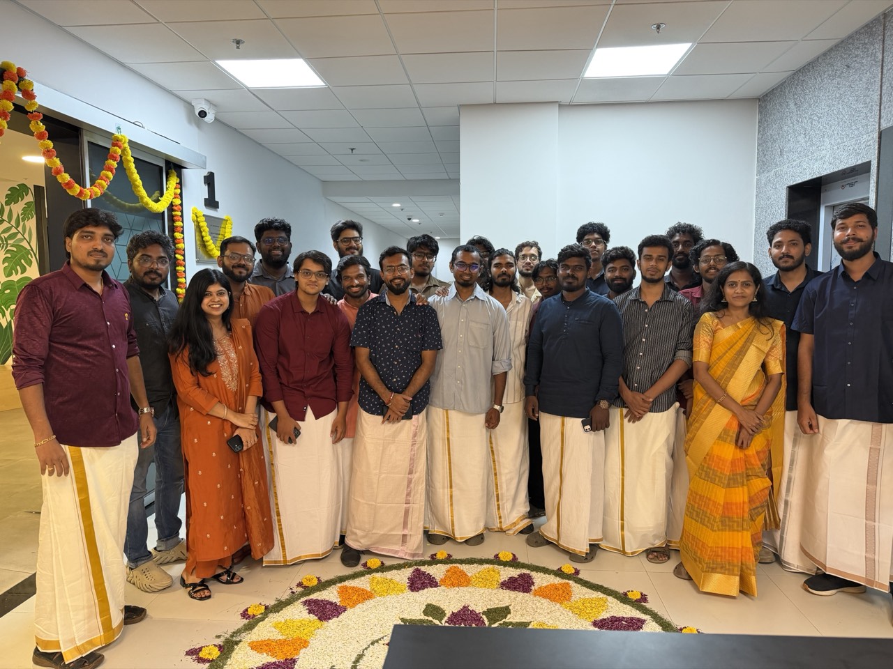The Ayelet Studio team together at their Chennai office, in traditional dress around a floral rangoli